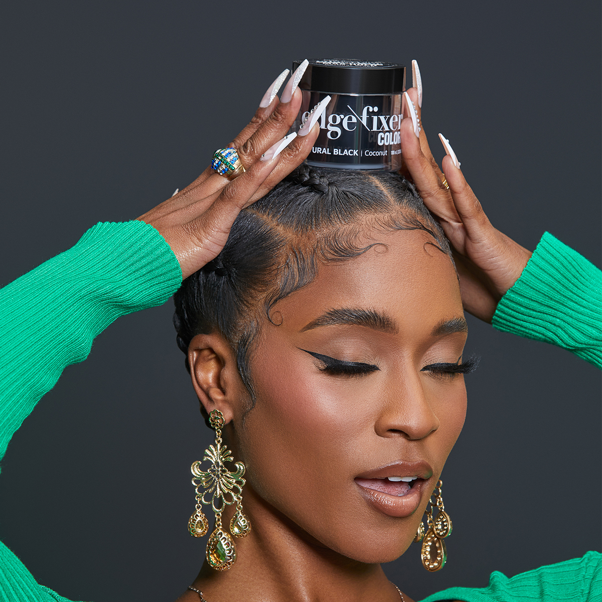Woman with styled edges and gold earrings holding a jar of KISS Colors & Care Edge Fixer Color 100mL Natural Black on her head; jar text highlights coconut formula.