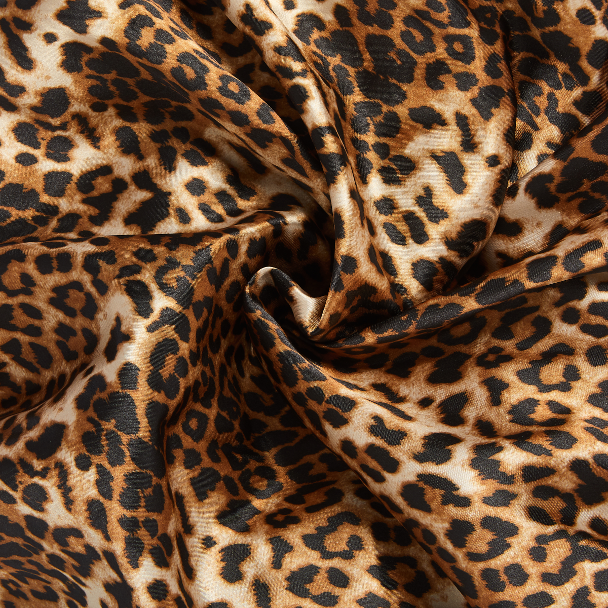 Leopard print silky satin fabric with smooth texture, showcasing the luxurious pattern and glossy finish of the KISS Double Wear Cap XL.