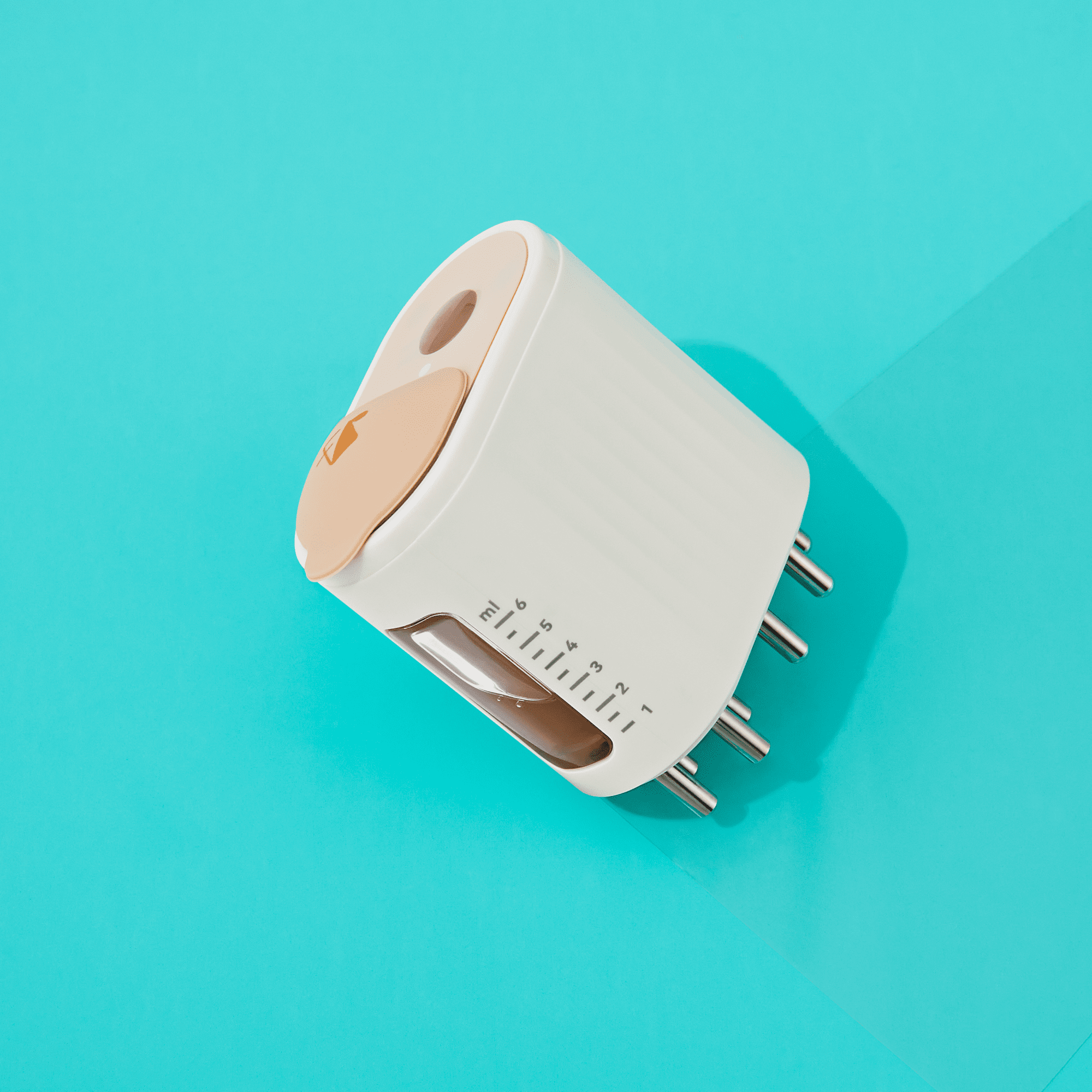 White and beige scalp stimulating applicator with metal massage nodes and a clear volume indicator against a blue background.