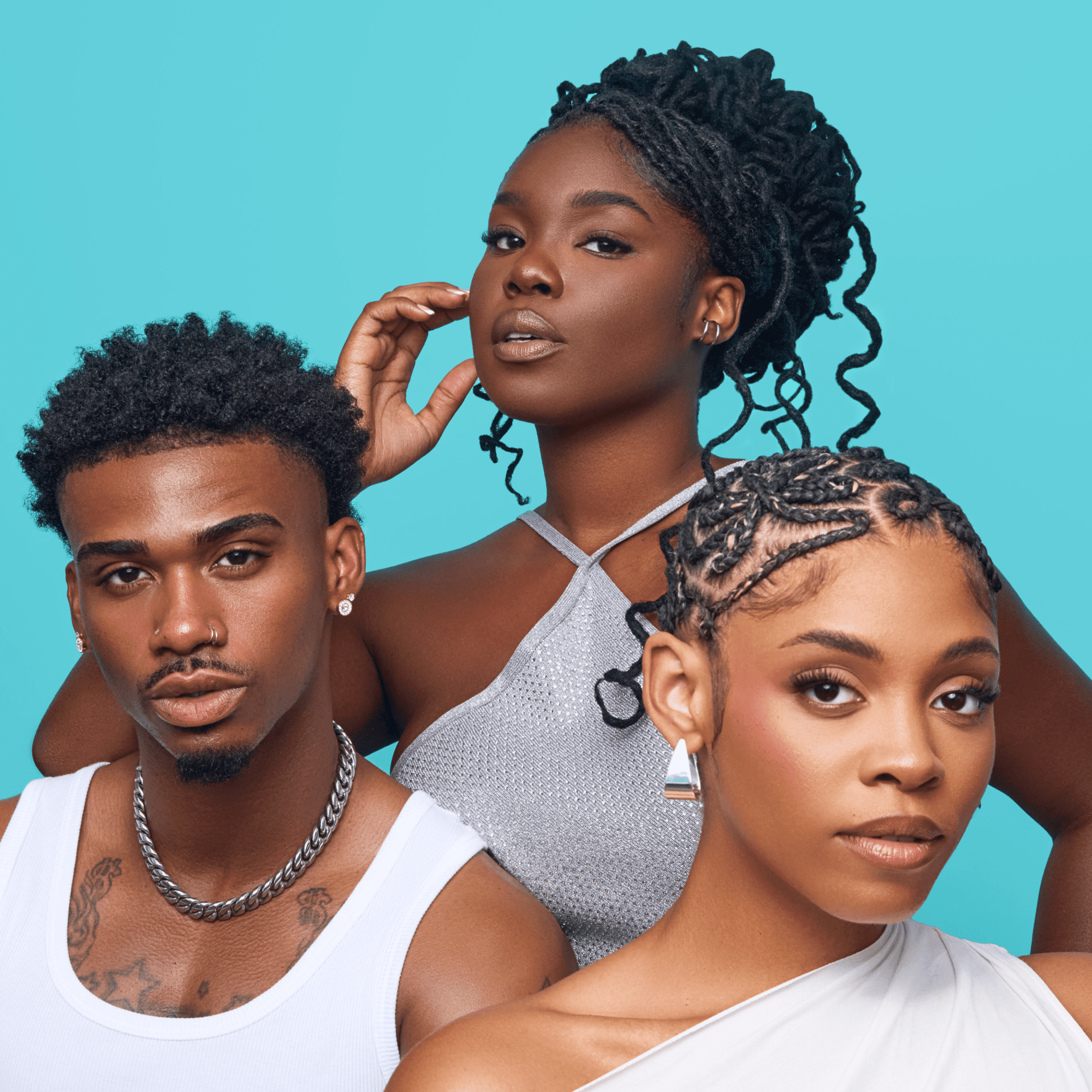 Three diverse models with natural hairstyles pose against a blue background, showcasing healthy hair and vibrant skin, promoting KISS Colors & Care Multivitamin Oil.