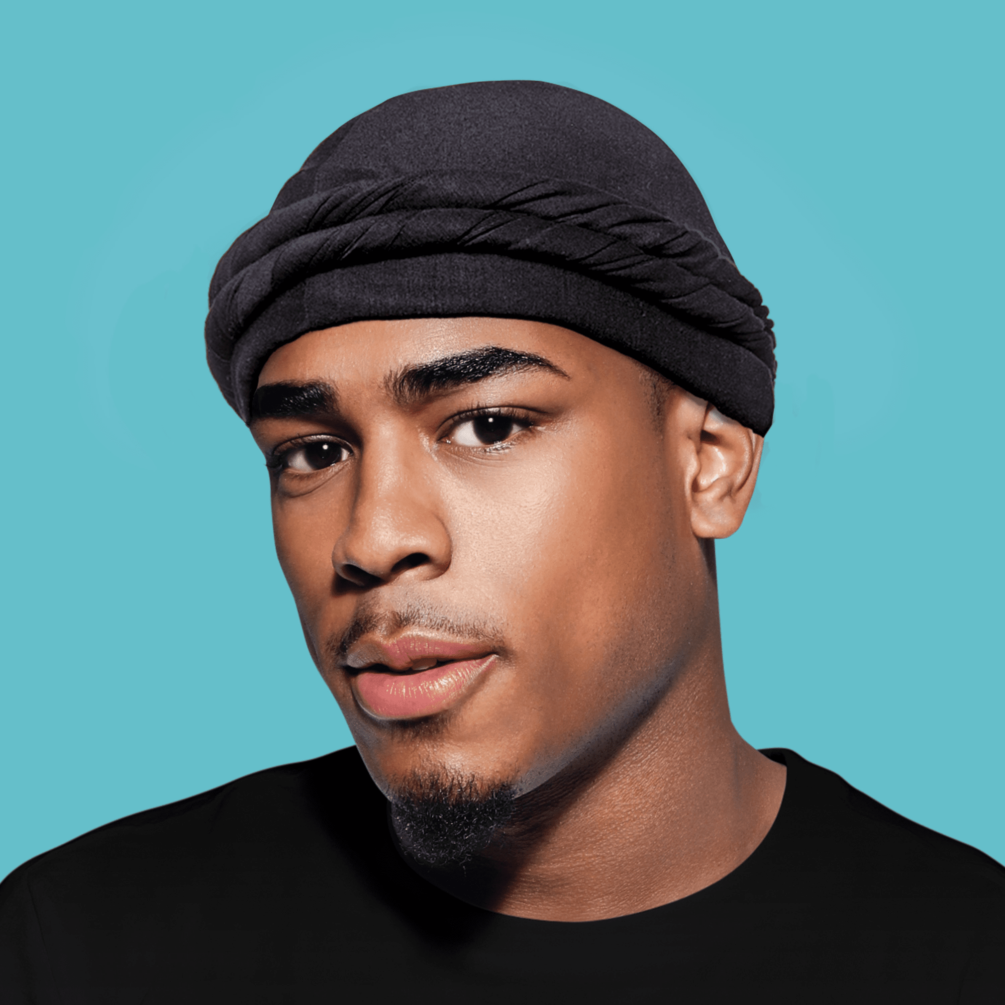 Black satin-lined halo turban worn by a man against a teal background, showing the turban&