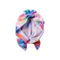 Soft and silky toddler turban wrap in vibrant tie-dye colors, featuring a pre-tied top knot bow and smooth interior fabric.