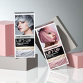 Two KISS Colors &amp; Care Lift Up Complete Bleach &amp; Tone Kits on geometric blocks. One with silver-gray "Ice" hair, the other with pink "Rose" hair.