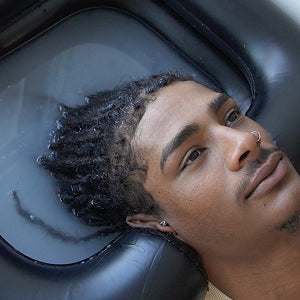 Person with styled hair looking into a mirror