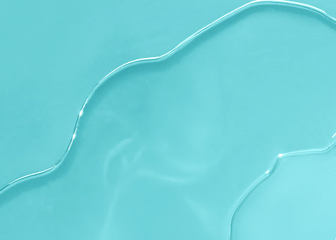 Clear blue liquid with smooth ripples on a light turquoise background, conveying freshness and purity.