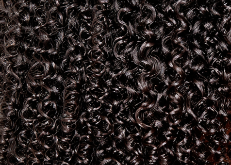 Close-up of densely packed, shiny black curly hair strands with tight, well-defined ringlets. No visible text.